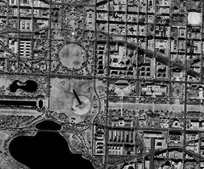 IKONOS-2 image, at approximately 5 meters resolution, of part of Washington, D.C., showing government buildings, monuments, the White House and its grounds, all clustered in and around the National Mall; note the Washington Monument and its shadow.