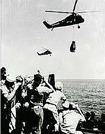 Shepard's capsule being flown to an aircraft carrier deck.