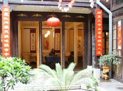 Tea house. In the old quarter of Kunming one traditional tea-house remains. To the sound of other clients shouting over cards and slamming
        dominoes down on the tables, we took tea