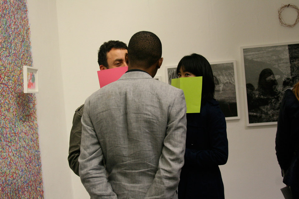 <p>Private Views, 2012 <br />Private Views is a live performance conducted for the private view of the Interim Show. In order to see the performance, the audience has to hold  the free-to-take bright colour paper up covering his/her mouth and his/her nose. Then, one of the performers will come to the audience and perform his/her chosen talent in front of the audience. To stop the performance is to simply put the paper down; the performer will walk away.</p>