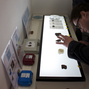 A researcher inspects some desert glass during the Lunar Salon