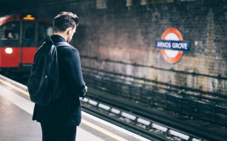 Man standing alone on a tube station platform