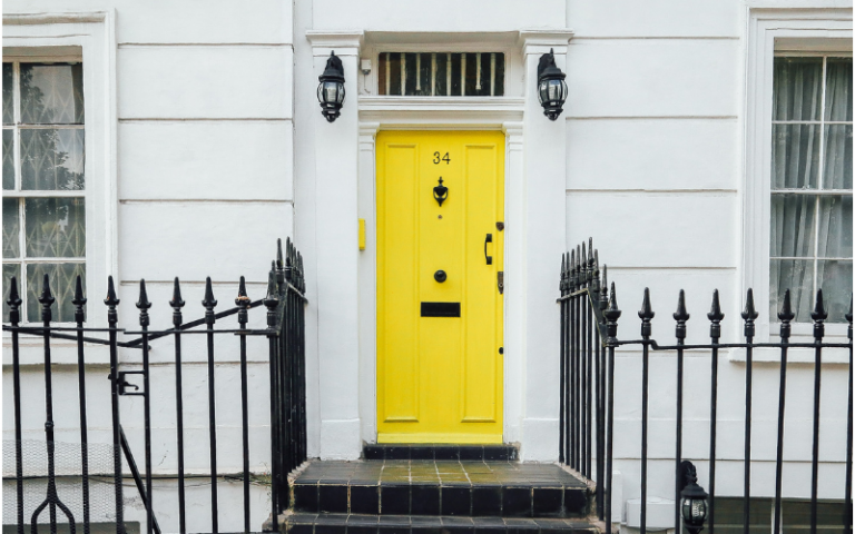 Yellow front door in London - Securing housing