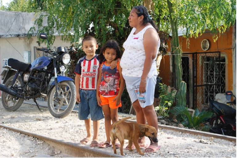 Photo of a woman, two children and a dog from a community affected by the Tren Maya railway project