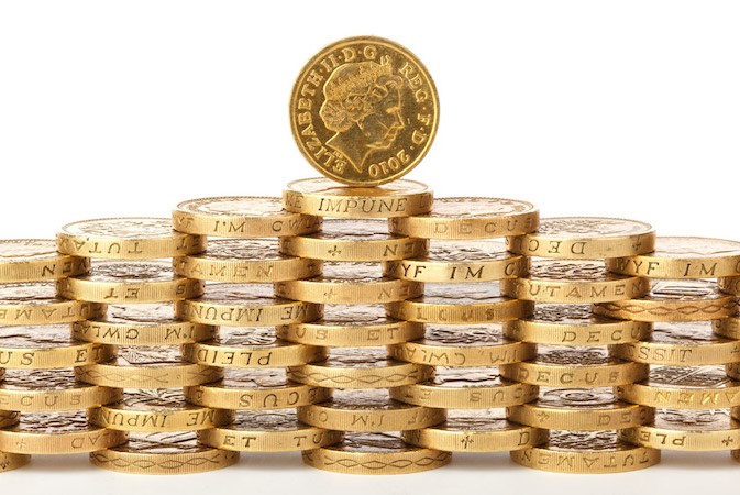 Image of several one pound Sterling coins stacked up