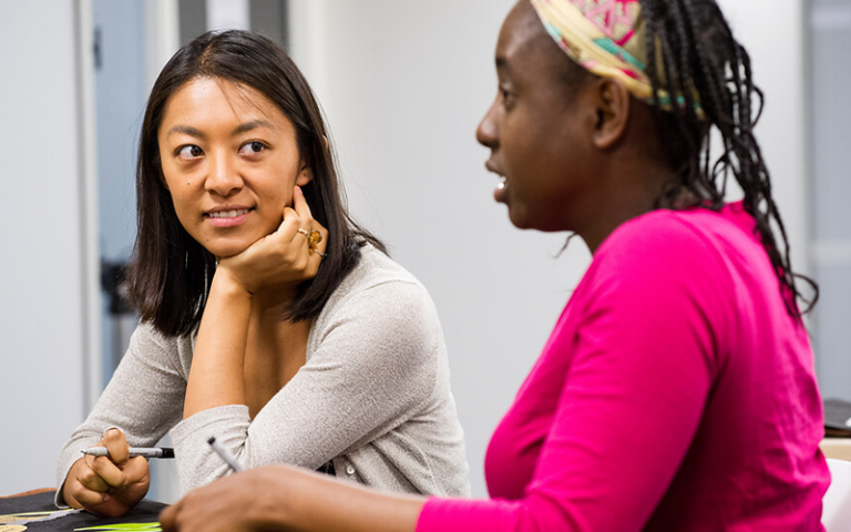 Photograph of UCL Americas Mexican alumna Jessica Harada Fernandez de Lara in conversation with an unidentified black female colleague
