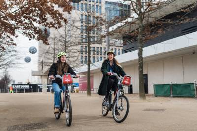 Female students cycling through Olympic Park