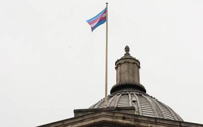 A view of UCL's Portico displaying the trans flag.