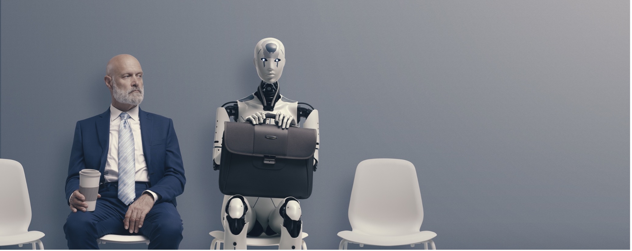 man sitting next to robot