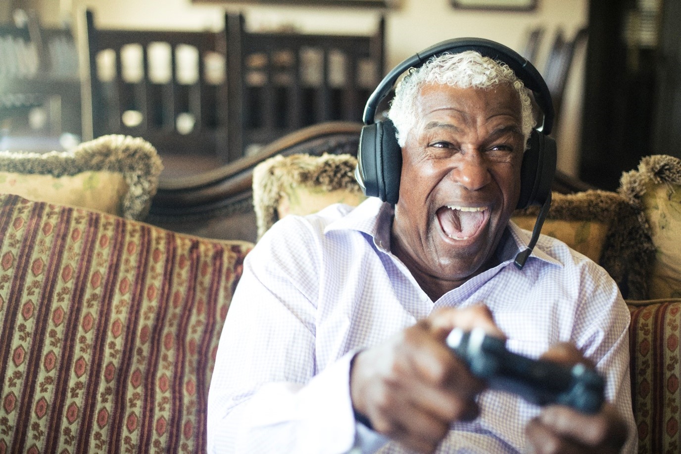 Man with headphones playing with controller
