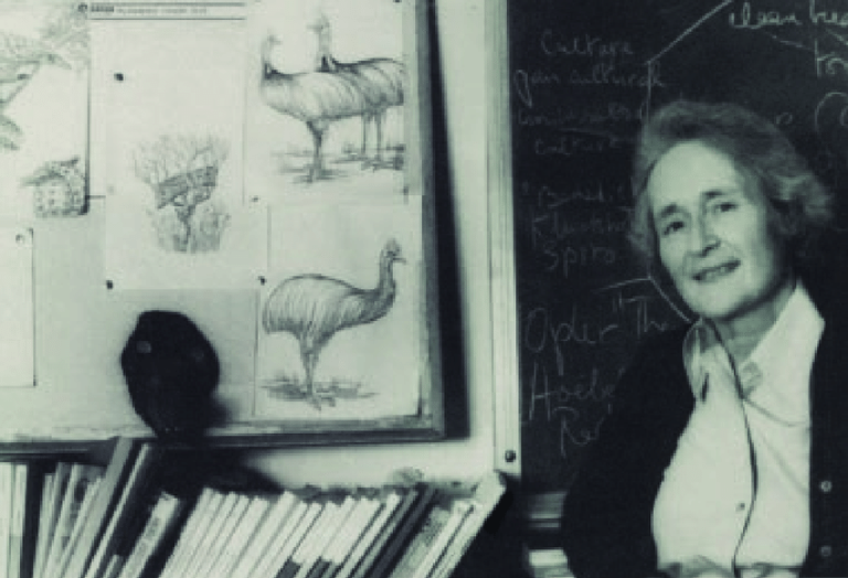 Professor Mary Douglas in front of a blackboard, drawings of animals and books