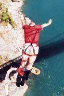 Man bungee jumping from bridge