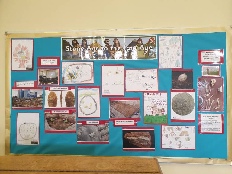 A wall display on the Stone Age with content drawn by Year 3 pupils