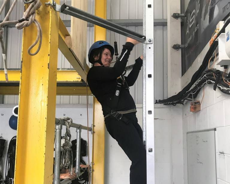 Letty climbs a ladder during Working at Heights training