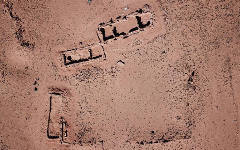 Overhead (drone) image of a sandy desert location with an archaeological excavation underway