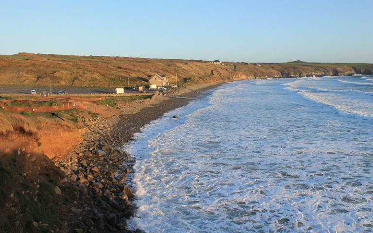 Looking across the Traeth Mawr beach – the arrow points to the area of excavation (Photograph by Stephen Kingston). 
