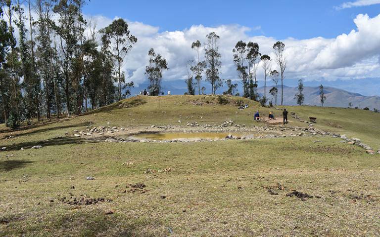 Landscape picture of an archaeological excavation taking place on a hillside