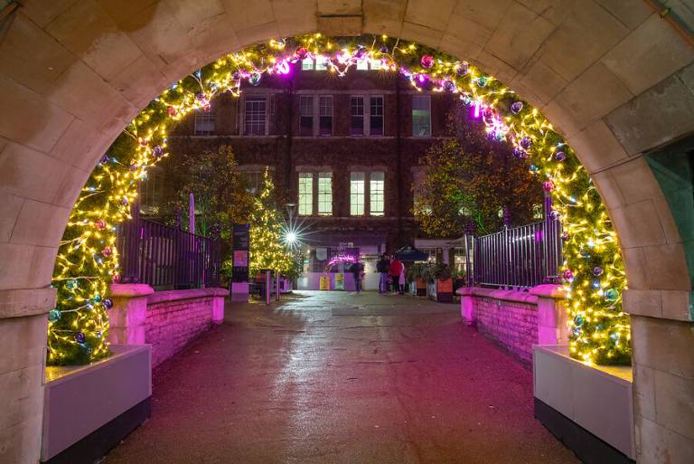 Yellow and pink Christmas lights surrounding an archway