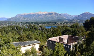 View across the remains of the former experimental reactor Number 1 and towards the city of San Carlos de Bariloche on Isla Huemul, Argentina