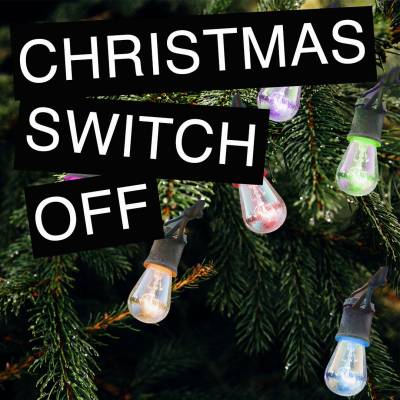 A close up of a Christmas tree decorated with different coloured light bulbs. Text 'Christmas Switch Off' superimposed in front of the tree