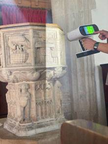 Digital equipment being used to record a stone font in a church building