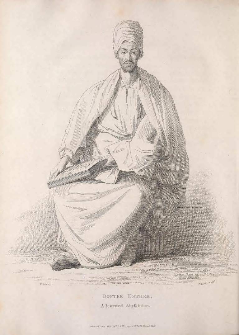 a black and white image of a man in robes holding a large book