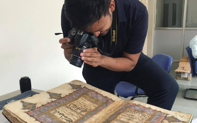 Dr Vivek Gupta is photographing a old manuscript