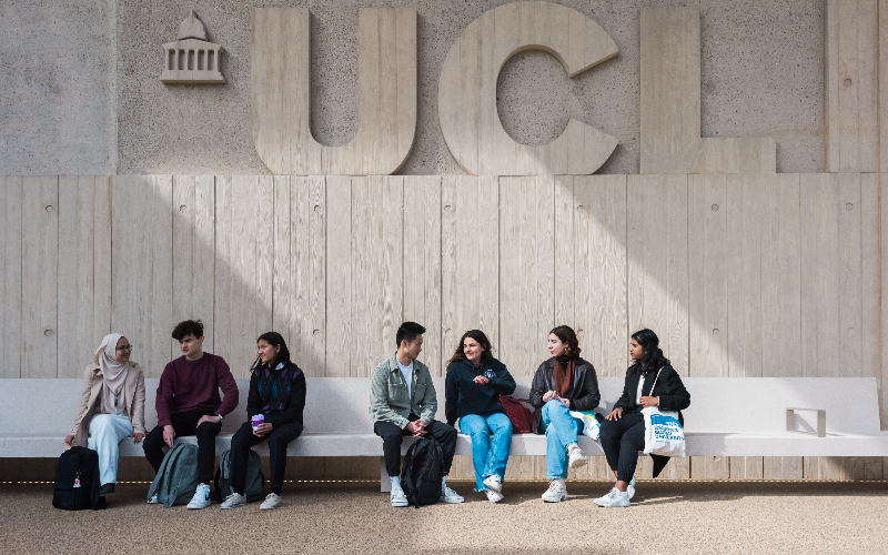 UCL staff sitting at UCL East on bench