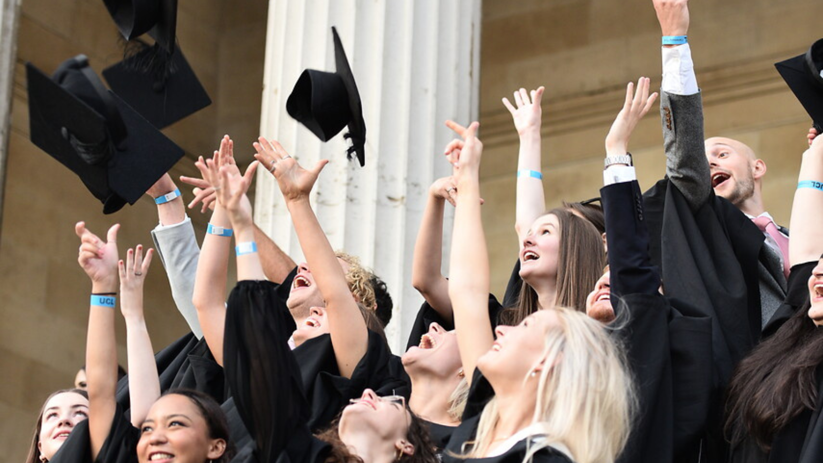 Graduates throwing their hats 