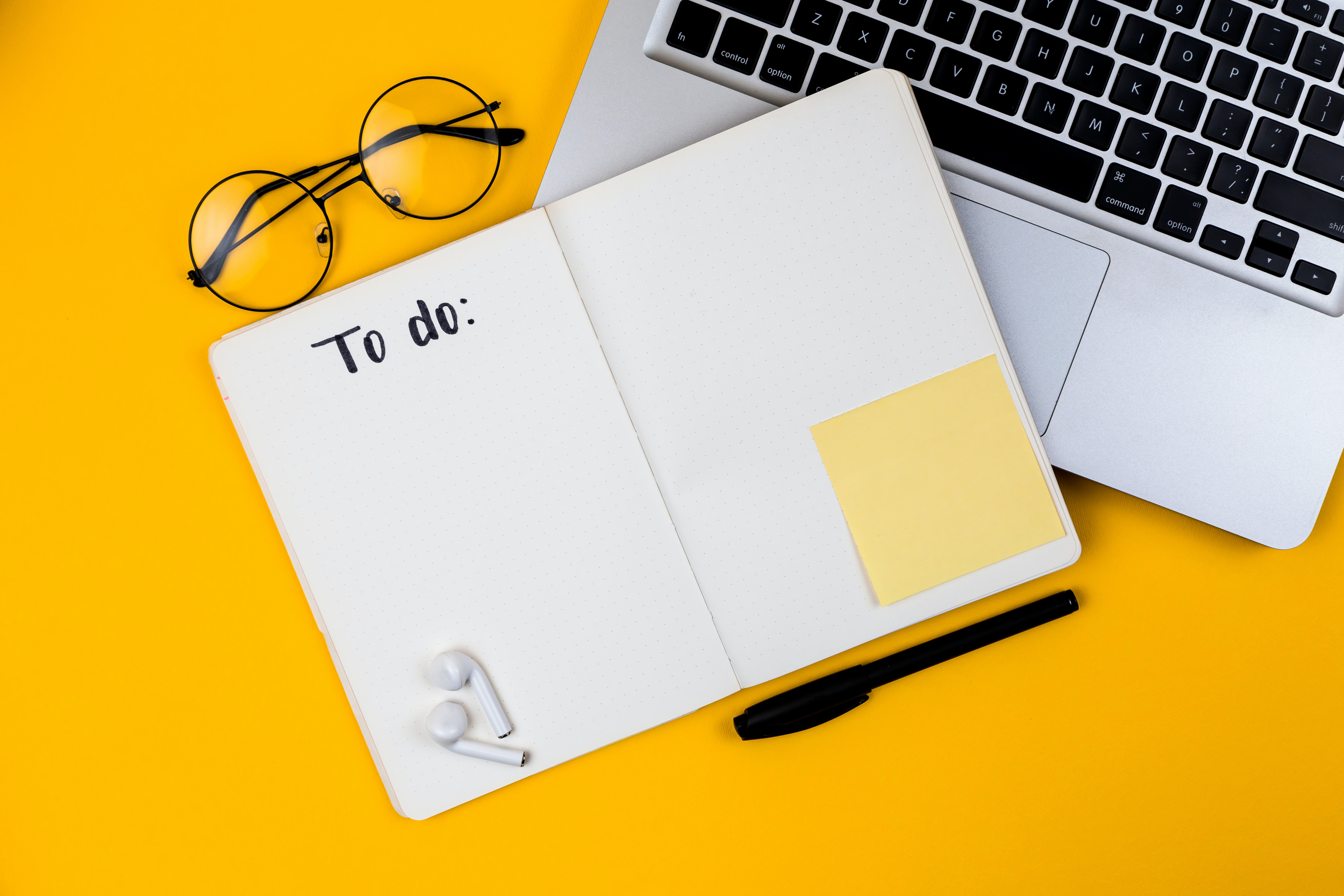 To do Notebook and laptop on yellow background