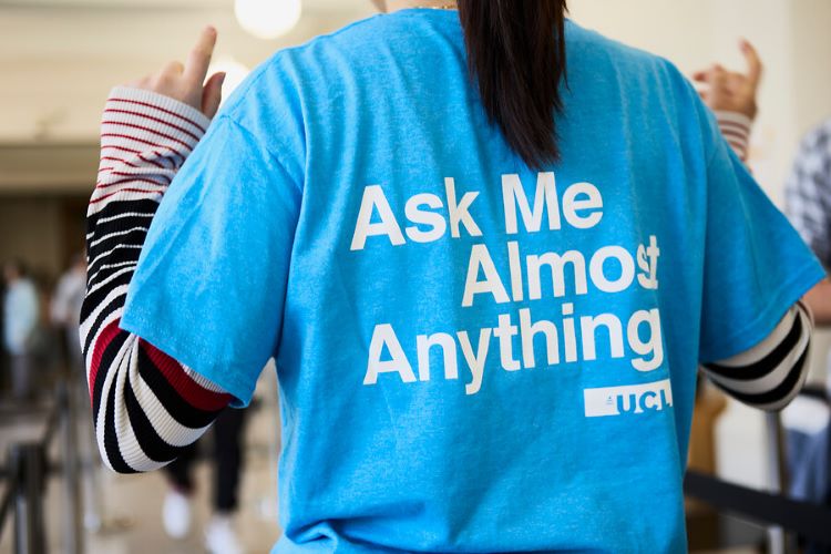 Student in a blue Ask Me Almost Anything tshirt