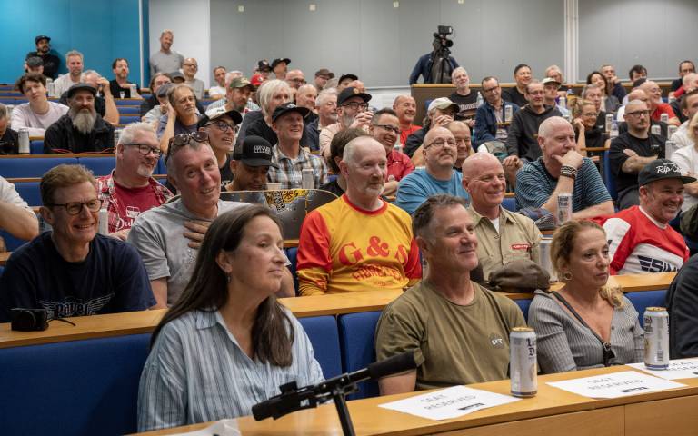 Audience smiling in a lecture theatre at the UK Skateboarding Forum