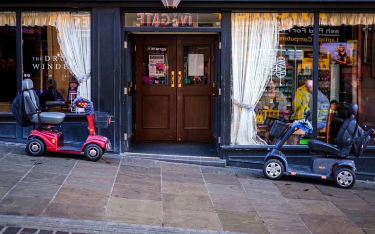 Pub lunch - Two mobility scooters parked outside the Drum Winder public house, Bradford. Photographer - Marcus Rattray