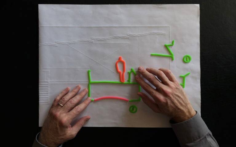 Chris Downey working on a project for the Blind Rehabilitation Center. Wax stick sketch on embossed section drawing of Lobby Bridge. Photography by Don Fogg.