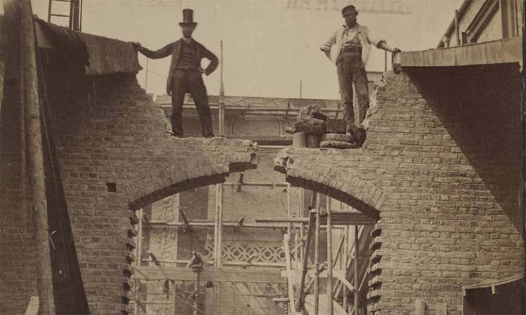 19th-century photograph of two men standing on a building site