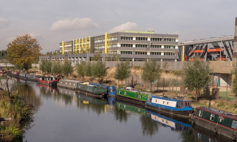 Here East building in the distance with canal and canal boats in the foreground
