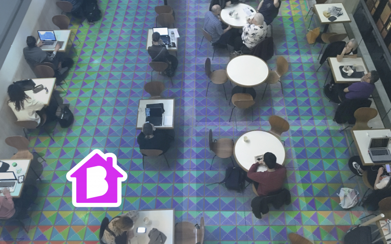 Birds-eye-view of a room of people sitting at tables. Image courtesy of Jaesik Chun. 
