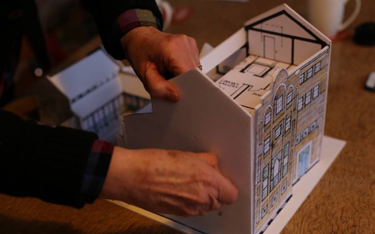 Demountable cardboard model of Jagonari Asian Women’s Centre, East London, by Matrix Feminist Design Collective (1984) being demonstrated as a participatory tool by architect Anne Thorne. Photograph by Maria Venegas Raba. 