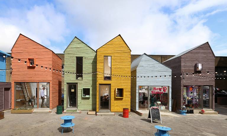A row of buildings styled as brightly coloured beach houses