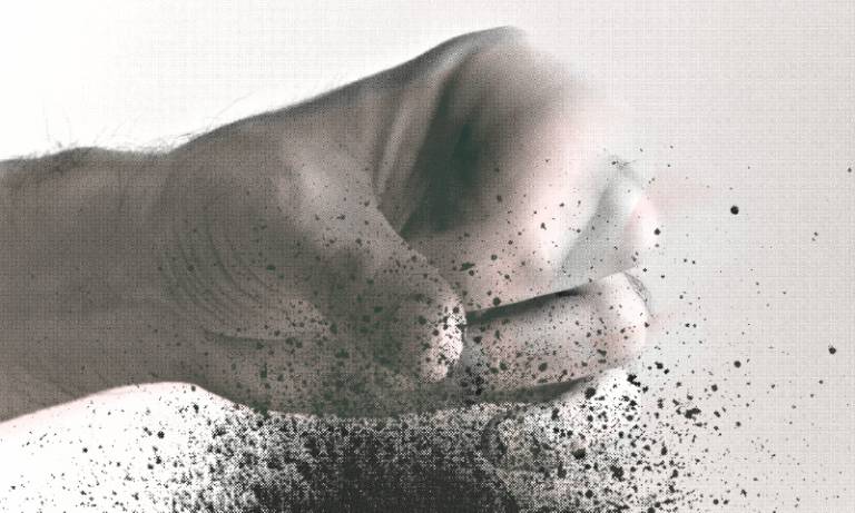  A hand releases a fistful of soil