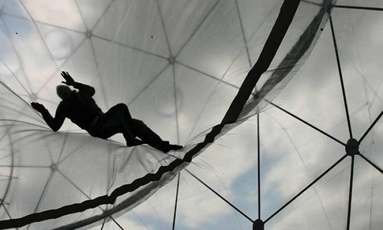 A man climbing on a glass roof