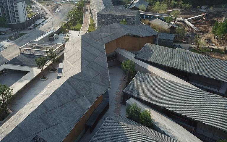 Roof tops of buildings which zig zag across the landscape
