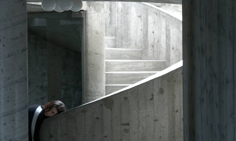 Woman leaning on a concrete staircase