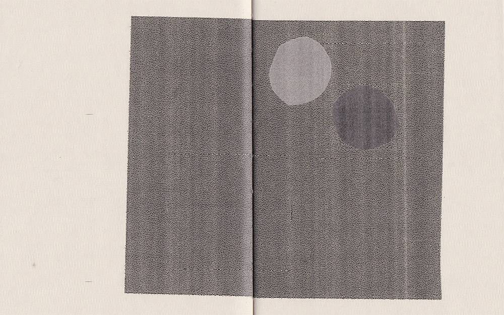 Two pages of a book with print of two circles
