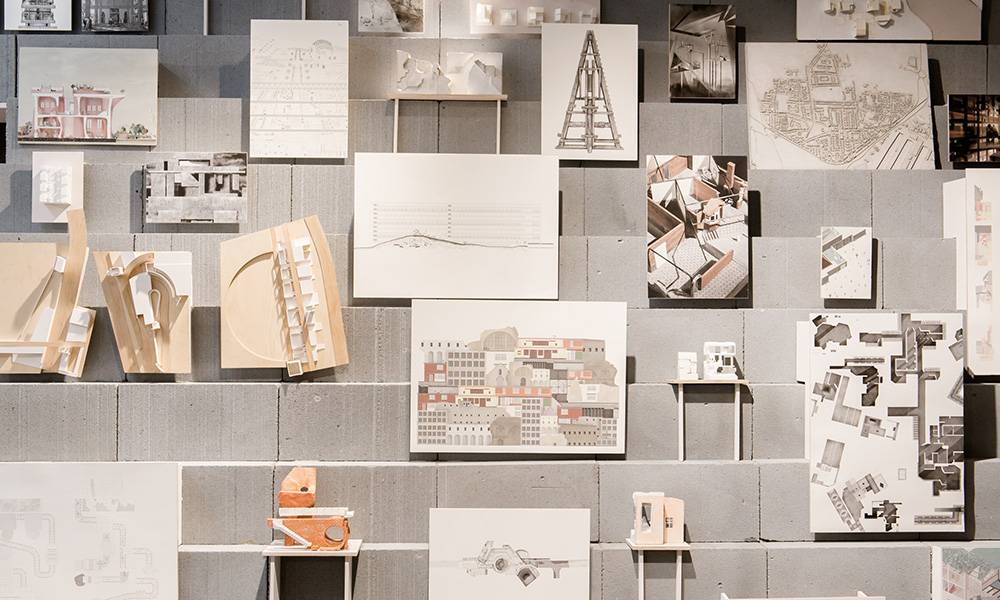 Three shelves with drawings and objects of architecture and buildings