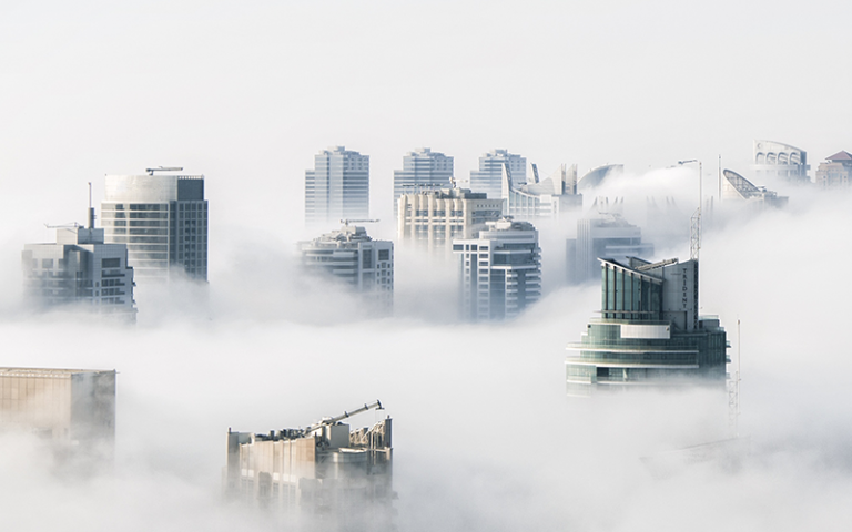 Castles in the air - aerial image of buildings covered in clouds