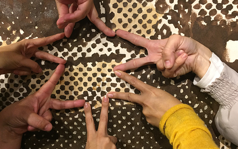 refugee hands and fingers in a circle