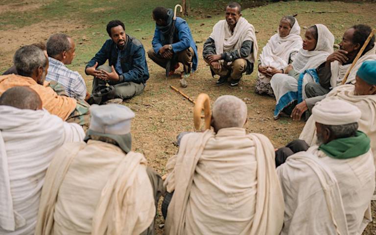 A group of people sitting in a circle talking