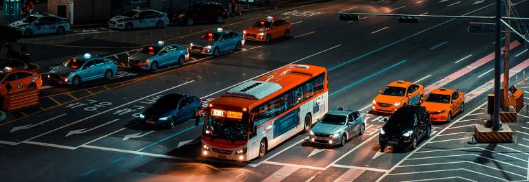 Photo of a buses, cars and taxi stopped at a traffic light