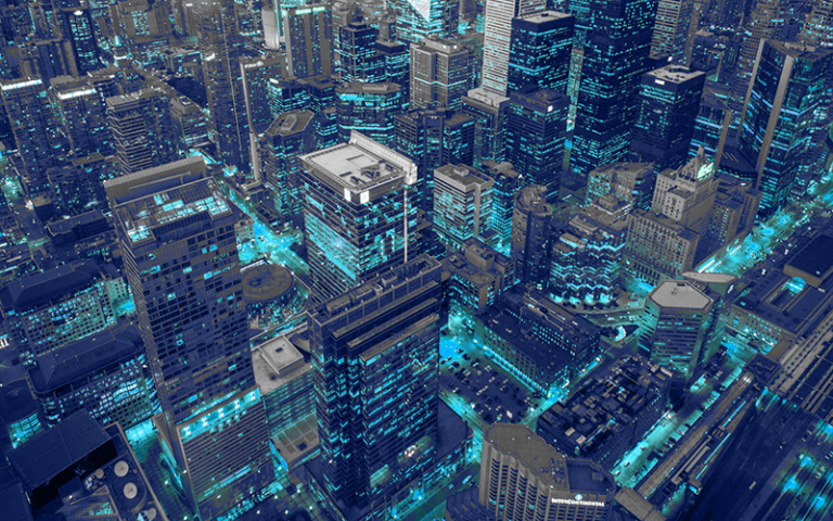 Aerial view of skyscrapers in city with blue lights